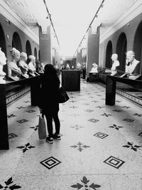Full length of woman walking on tiled floor