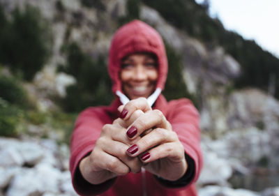 Unfocused portrait of a woman stretches her sweatshirt cord.