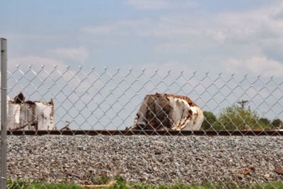 View of barbed wire fence against sky