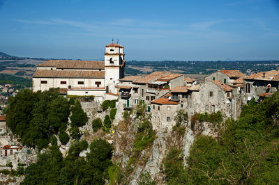 High angle view of townscape by sea against sky