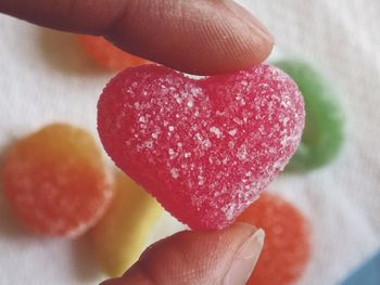 Close-up of hand holding a candy