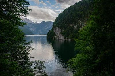 Scenic view of lake by mountains against sky