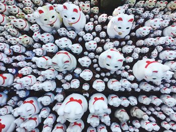 Full frame shot of white cat figurines for sale in market