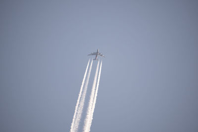 Low angle view of airplane flying against clear sky