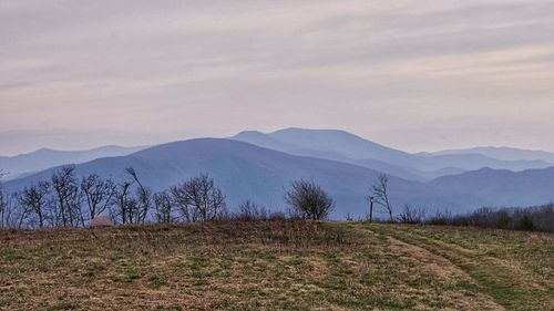 Scenic view of landscape against cloudy sky