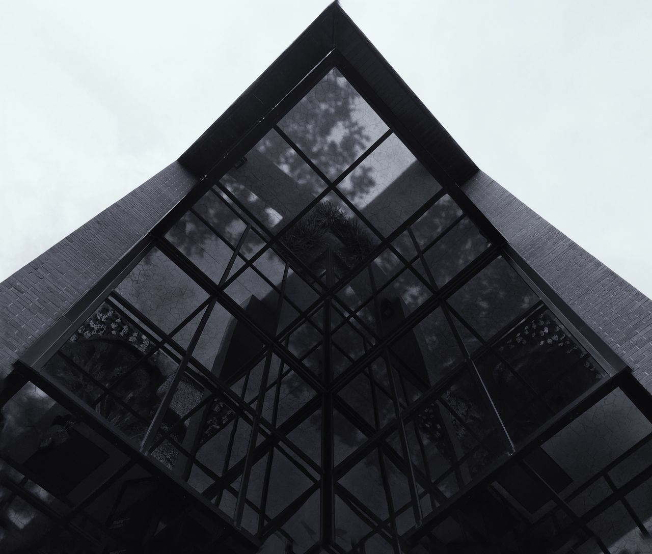 architecture, low angle view, building exterior, built structure, window, glass - material, building, modern, sky, office building, reflection, clear sky, city, day, no people, tall - high, outdoors, architectural feature, residential building, tower