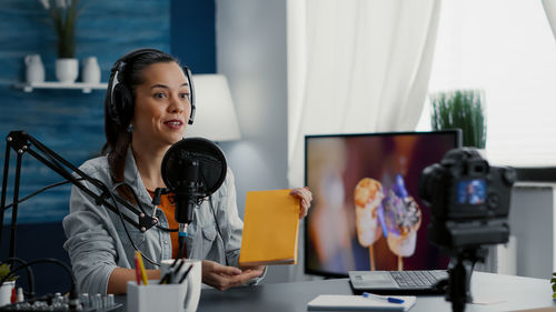 Portrait of businesswoman using laptop at office