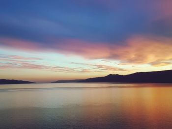 Scenic view of sea against romantic sky at sunset