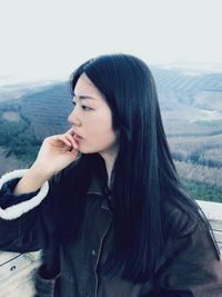 Side view of thoughtful young woman standing at observation point