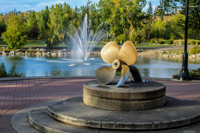 Fountain in lake against trees