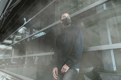 Thoughtful man standing in smoke