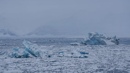 Scenic view of frozen lake against sky