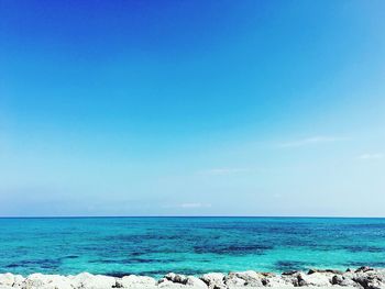 Scenic view of sea against clear blue sky