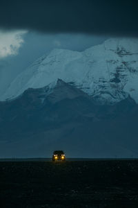 Scenic view of snowcapped mountains against sky during sunset