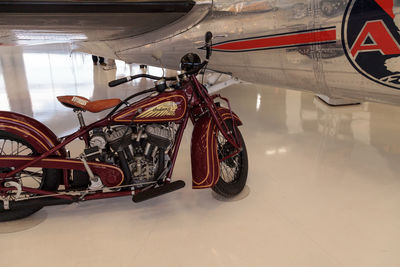 Close-up of motorcycle hanging on bicycle