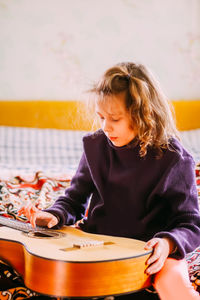 Little girl playing guitar