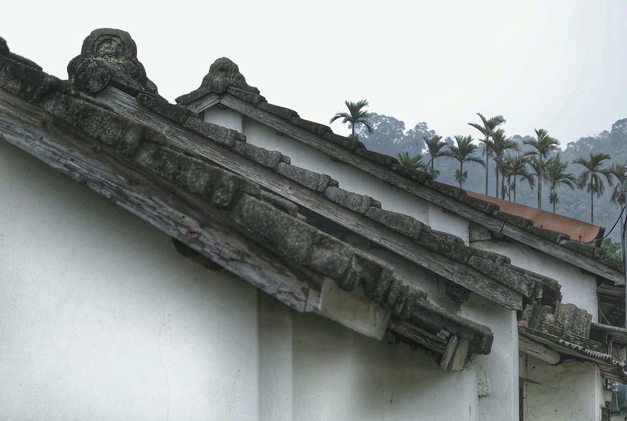 High section of old houses against clear sky