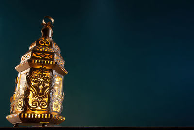 Low angle view of statue against blue background