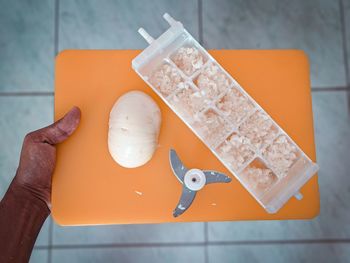 High angle view of person holding bread on table