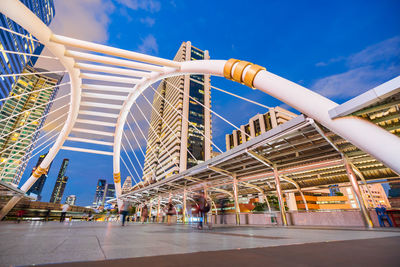 View of bridge and buildings against blue sky