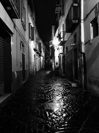 Empty alley amidst buildings in city