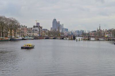 Scenic view of river and buildings against sky