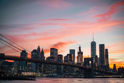 View of bridge over river at sunset