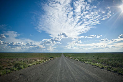 Country road passing through field