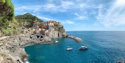 Panoramic view of sea and buildings against sky