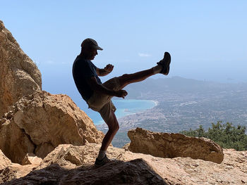 Man standing on mountain against sky