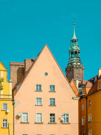 Old facades of houses in european city. cozy pastel color houses with tiled roofs in wroclaw, poland