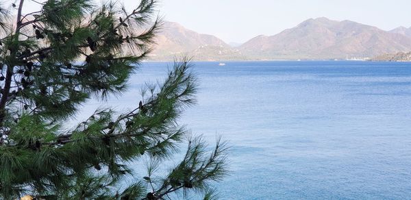 Scenic view of sea and mountains against sky