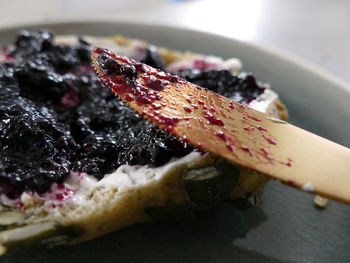 Close-up of butter knife by breakfast in plate on table