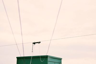 Low angle view of telephone pole against sky