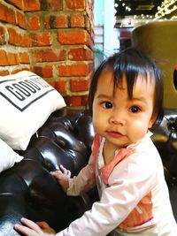 Portrait of cute girl on sofa at home