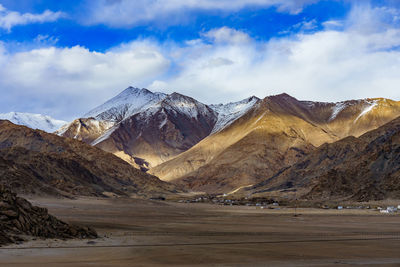 Scenic view of snowcapped mountains against sky