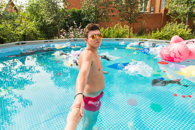 Portrait of shirtless boy in swimming pool