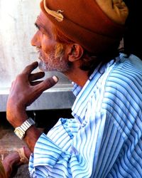 Side view of young man using mobile phone