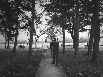 Rear view of woman walking on footpath