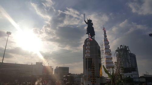 Low angle view of statue against cloudy sky