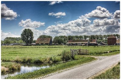 Scenic view of farm against sky