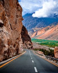 Road amidst mountains against sky