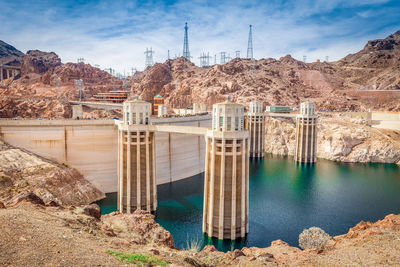 View of dam by river against sky