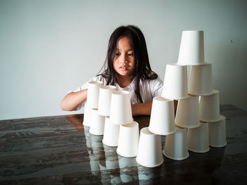 Girl stacking glasses