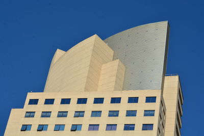 Low angle view of modern building against clear blue sky