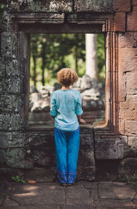 Rear view of a woman looking up outdoors