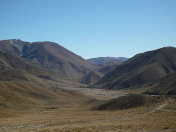 Scenic view of mountains against clear blue sky