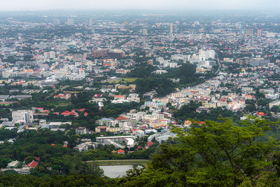 High angle view of townscape against trees in city