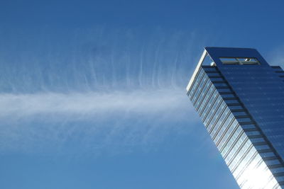 Low angle view of skyscraper against clear blue sky