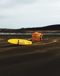 View of boat moored on beach against sky